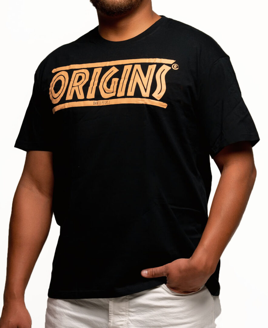 ORIGINS black and gold t-shirt featuring raw hand-lettered tribal seal design celebrating African roots as precious golden legacy and ancestral pride